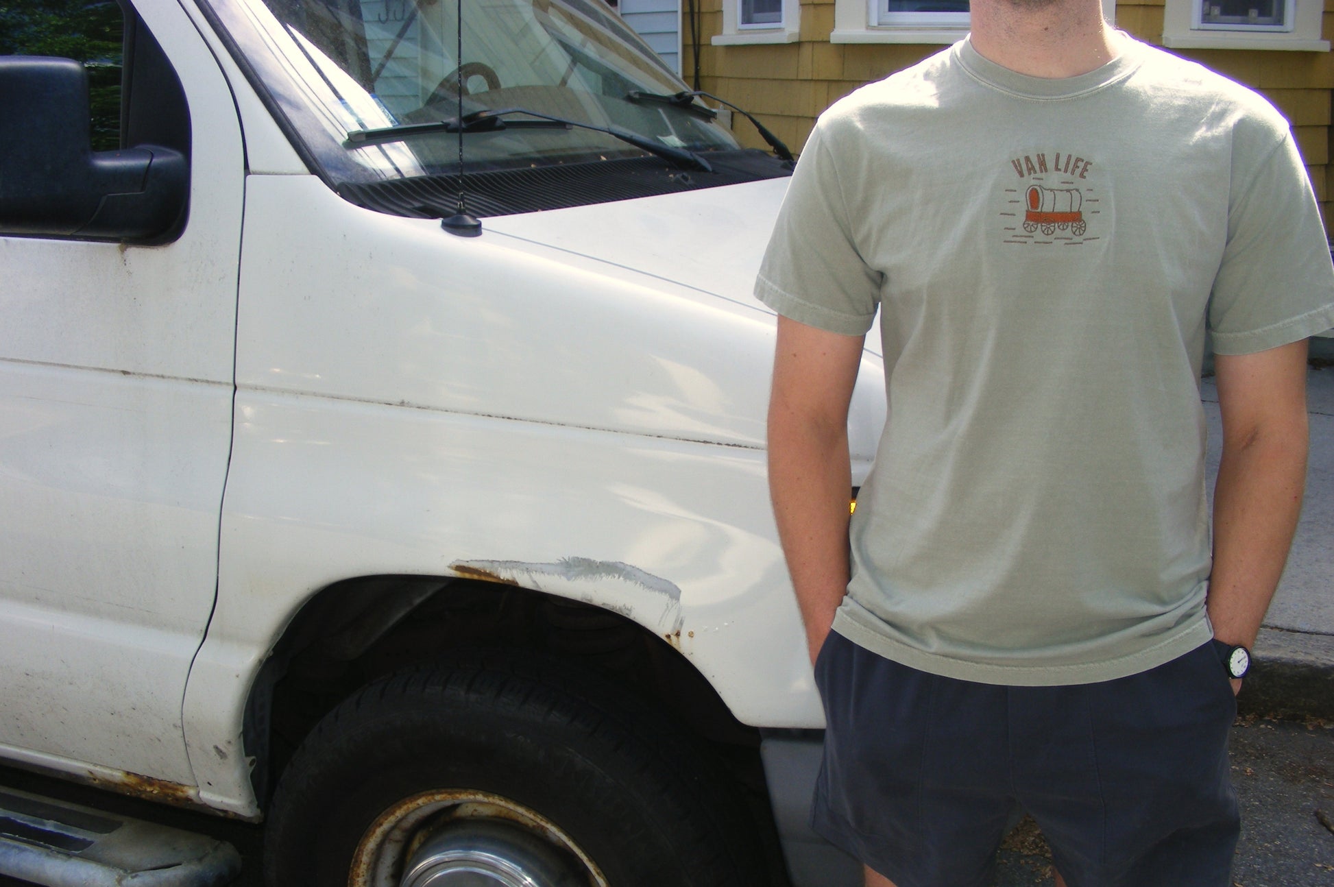 Model wearing Van Life shirt by Broider outdoors. Embroidered cotton tee for vanlifers and road trip lovers, made in Boston.