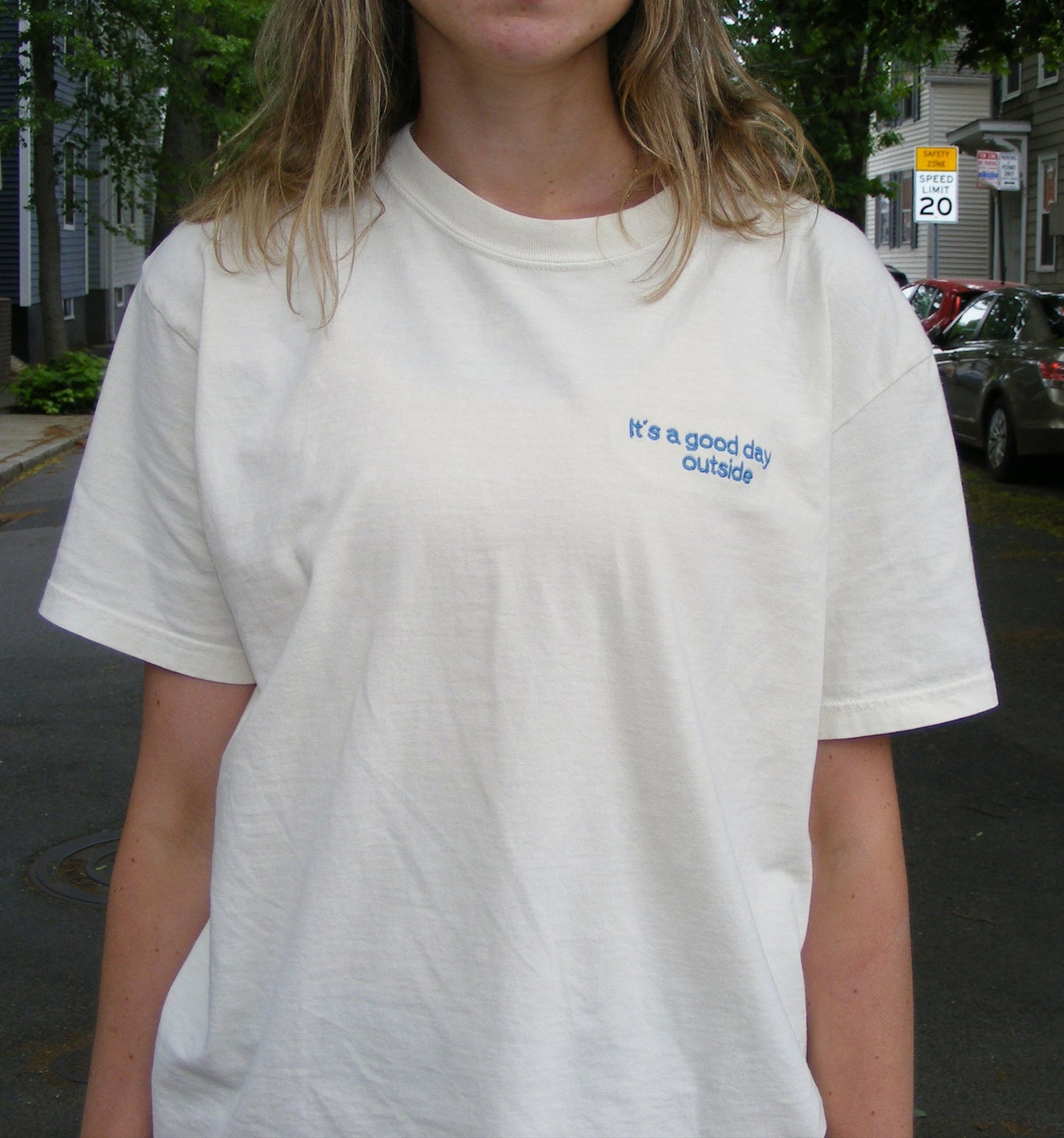 Model wearing It’s a Good Day Outside shirt by Broider. Positive embroidered shirt for everyday wear, stitched in Boston.