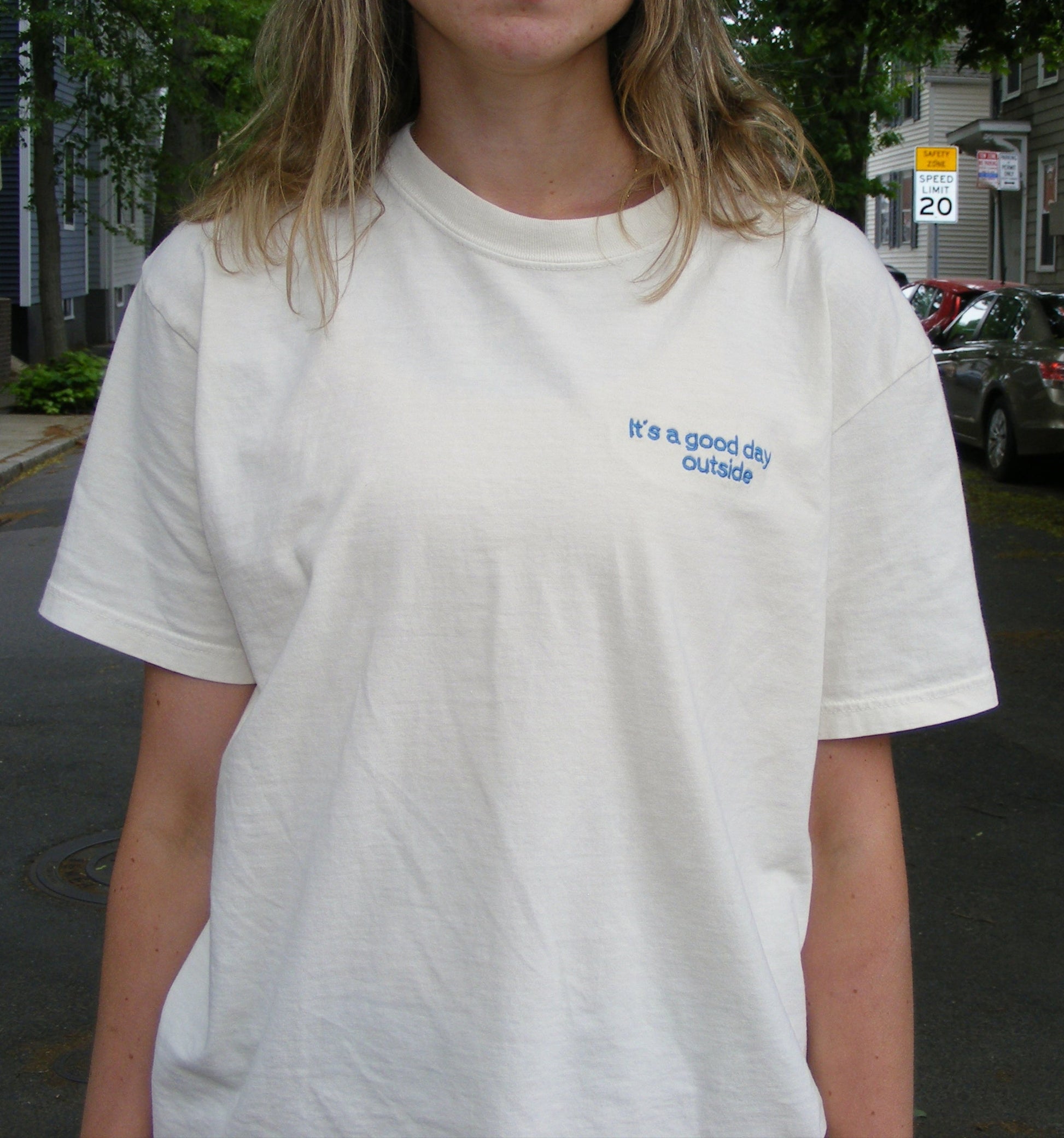 Model wearing It’s a Good Day Outside shirt by Broider. Positive embroidered shirt for everyday wear, stitched in Boston.